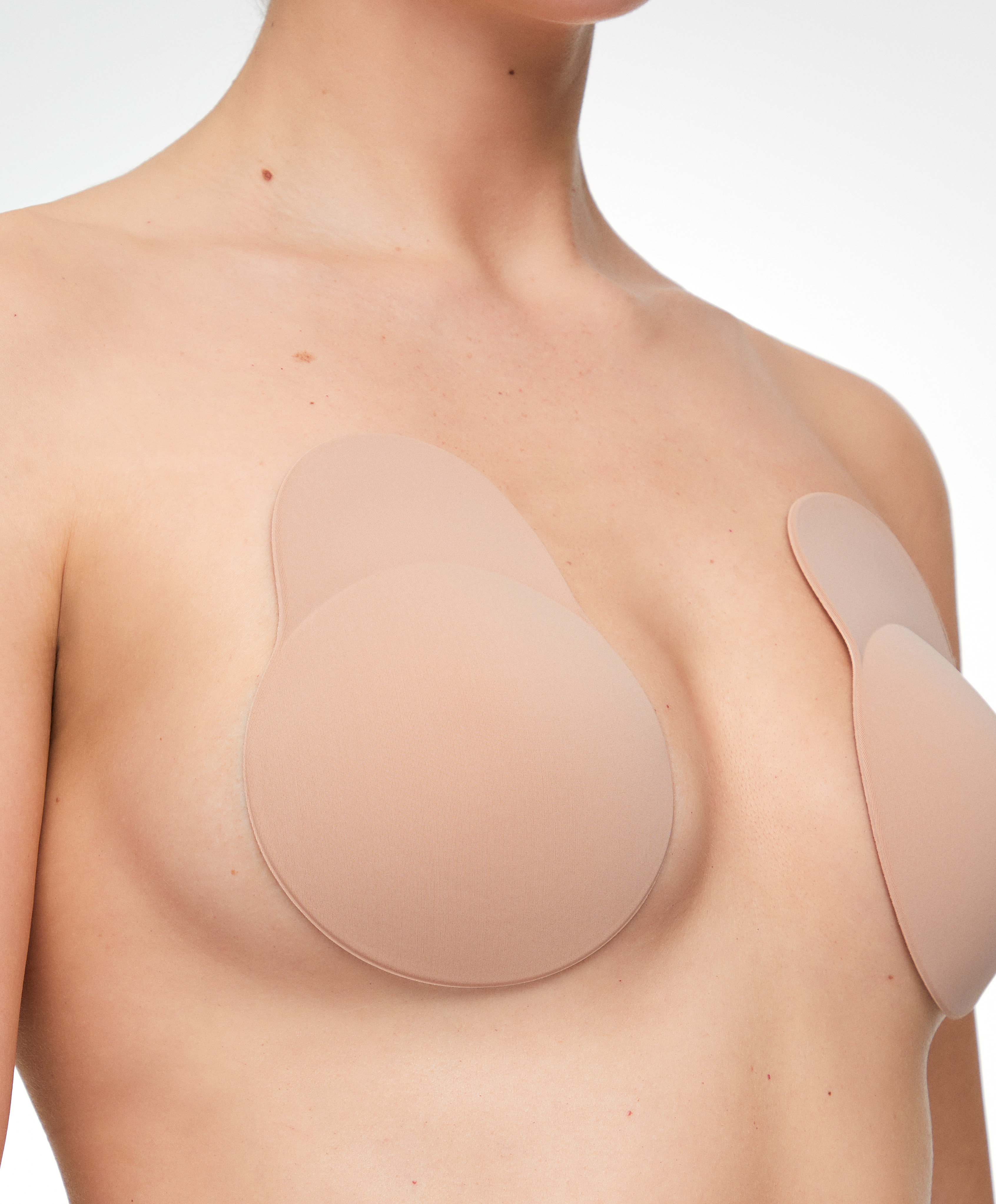 Adhesive fabric bust-enhancing cups