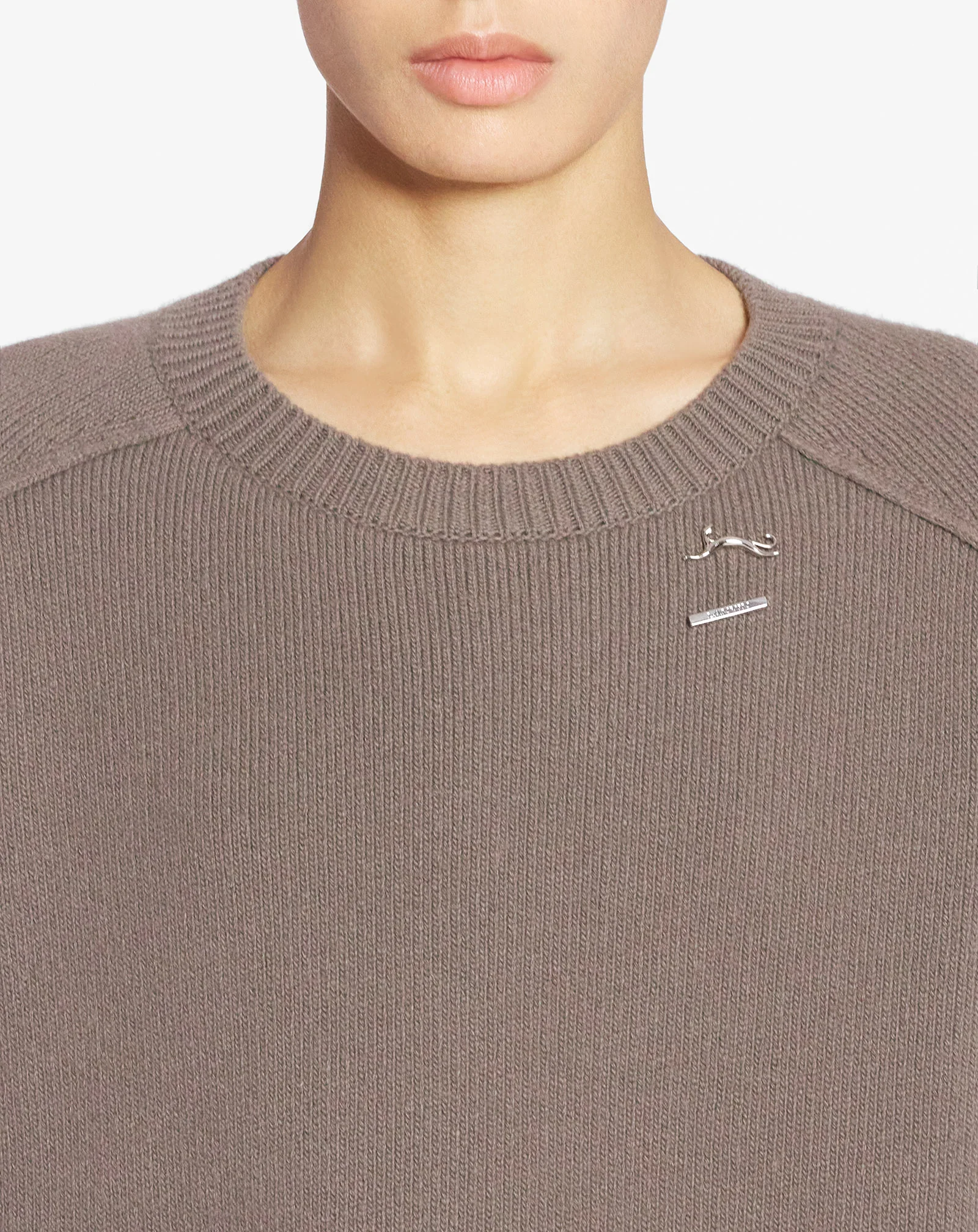 Cape sweater with a cat pin